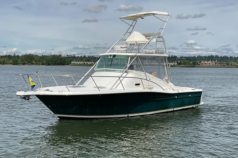 Slide: The Image of 1999 Pursuit OFFSHORE EXPRESS boat on calm water under cloudy sky. - 6