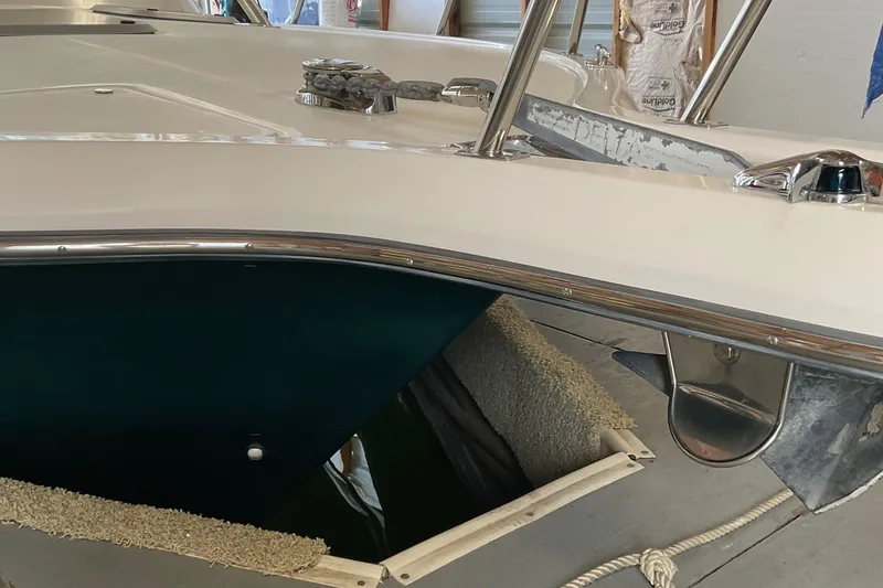 Slide: The Image of 1999 Pursuit OFFSHORE EXPRESS boat in storage, showing deck and anchor details. - 9