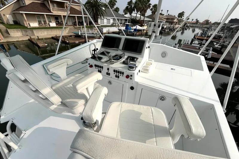Slide: The Image of 1972 Hatteras 42 Convertible yacht helm station with dual captain chairs and navigation equipment. - 10