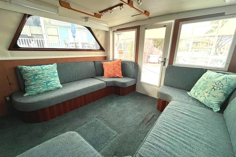 Slide: The Image of Interior of 1972 Hatteras 42 Convertible yacht with blue seating and colorful pillows. - 15