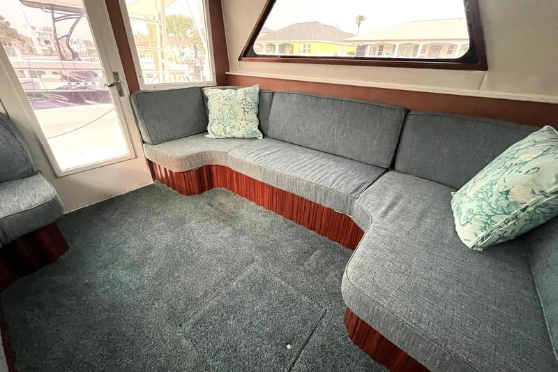 Slide: The Image of Interior of 1972 Hatteras 42 Convertible with grey seating and decorative pillows. - 16