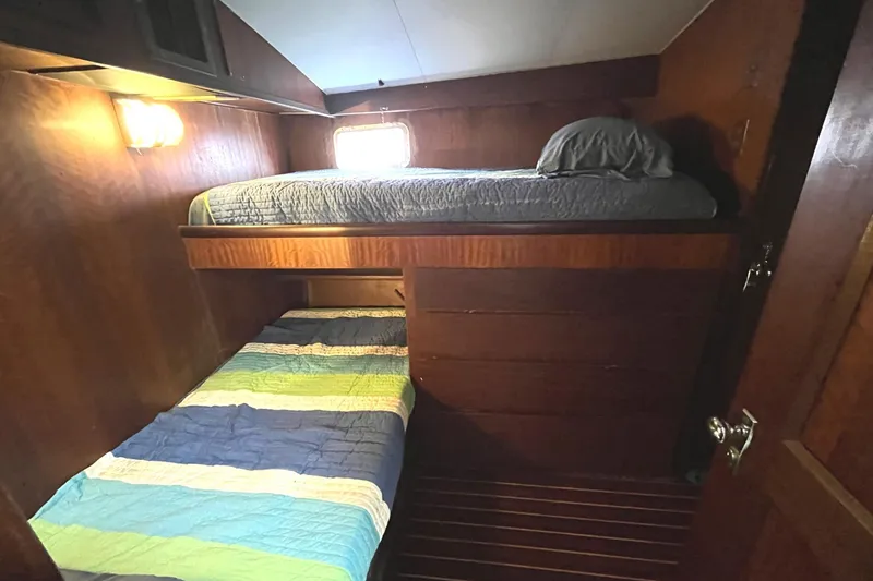 Slide: The Image of 1972 Hatteras 42 Convertible cabin with bunk beds and wooden interior. - 21