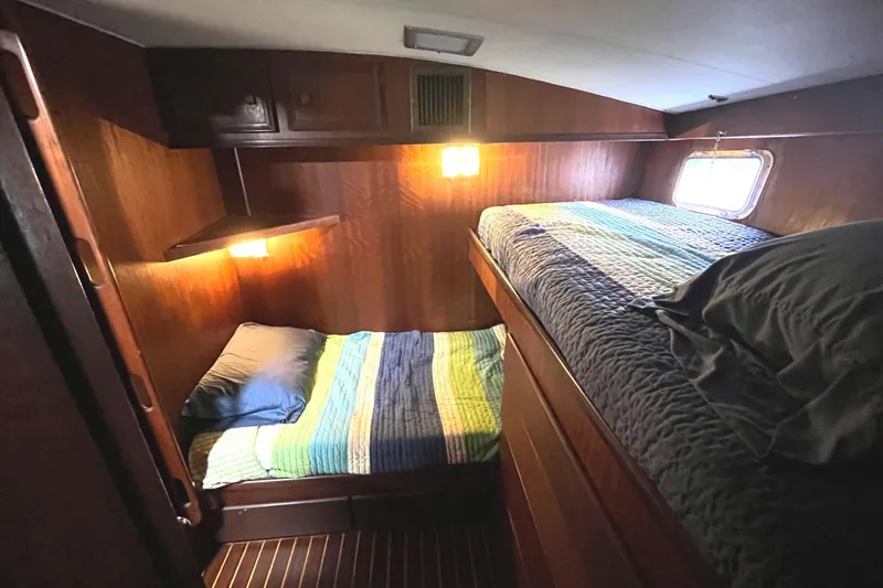 Slide: The Image of 1972 Hatteras 42 Convertible cabin with bunk beds and wooden interior. - 22