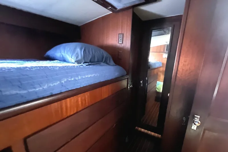 Slide: The Image of Interior cabin of 1972 Hatteras 42 Convertible with wooden bunk beds. - 23