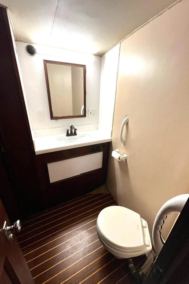 Slide: The Image of 1972 Hatteras 42 Convertible yacht bathroom with wooden flooring and modern fixtures. - 26