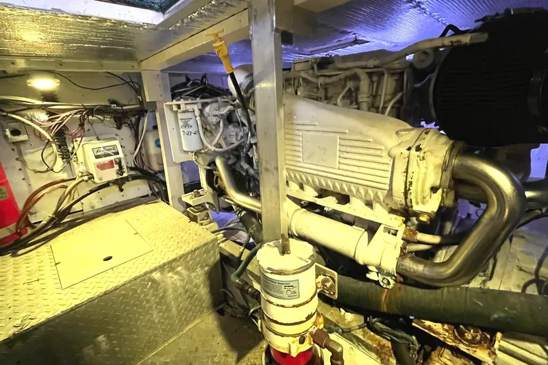 Slide: The Image of Engine room of a 1972 Hatteras 42 Convertible boat with visible machinery and wiring. - 30