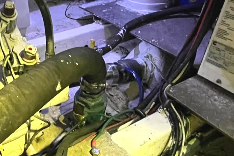 Slide: The Image of Engine room of a 1972 Hatteras 42 Convertible boat showing hoses and wiring. - 34