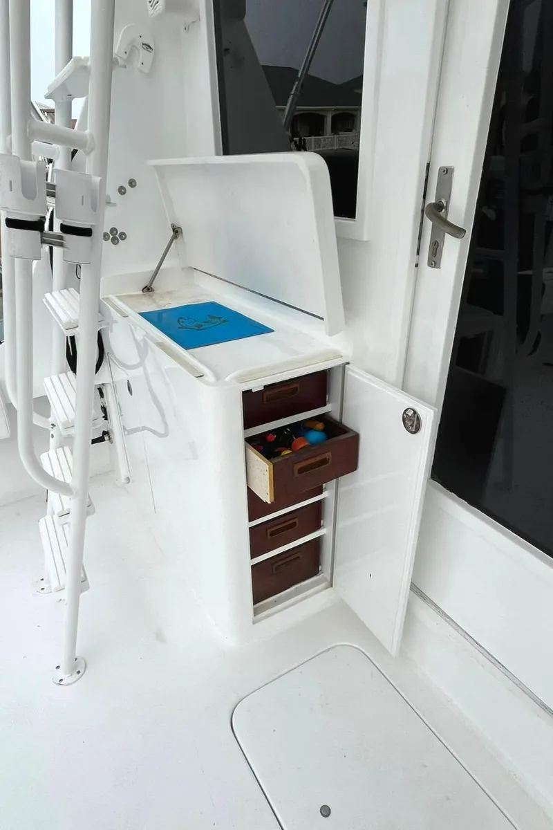 Slide: The Image of 1972 Hatteras 42 Convertible boat interior with storage drawers and ladder. - 5