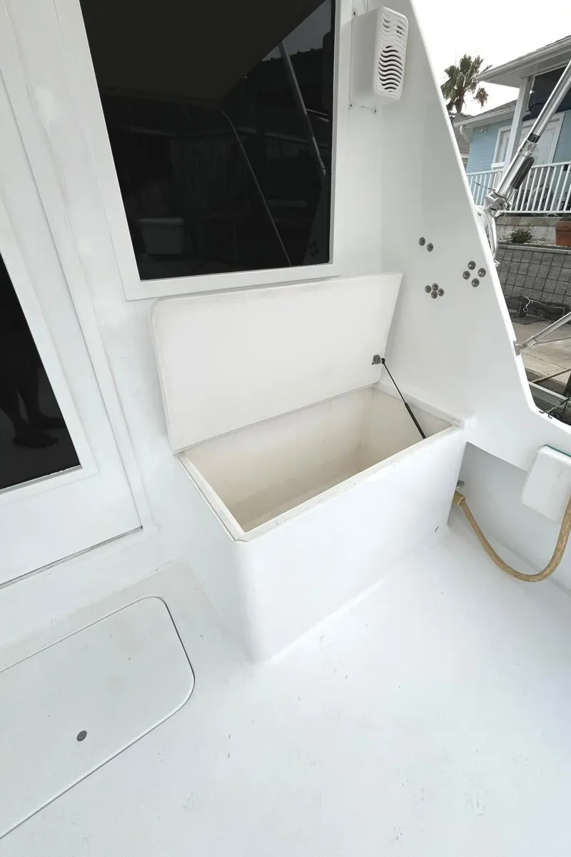 Slide: The Image of 1972 Hatteras 42 Convertible boat with open storage compartment on deck. - 6