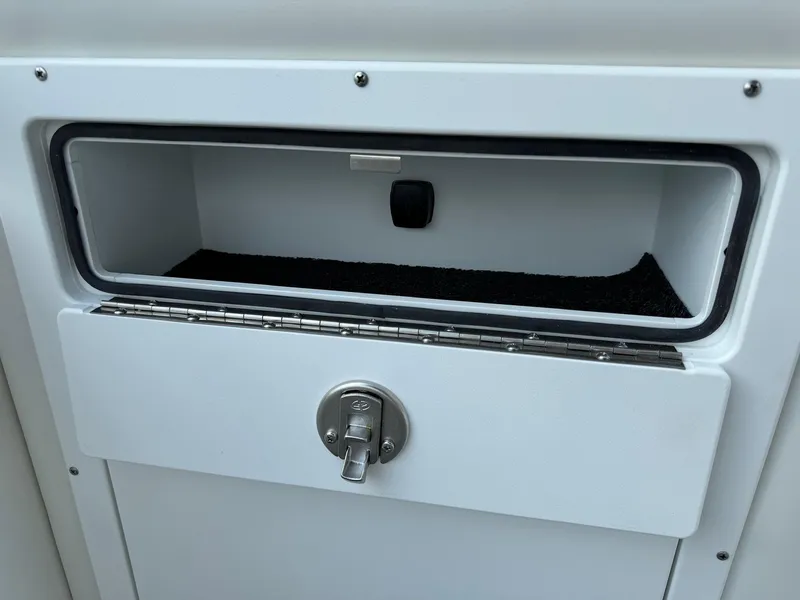 Slide: The Image of 2024 JC Spirit Super Sport 24TT DSL storage compartment with lock. - 11