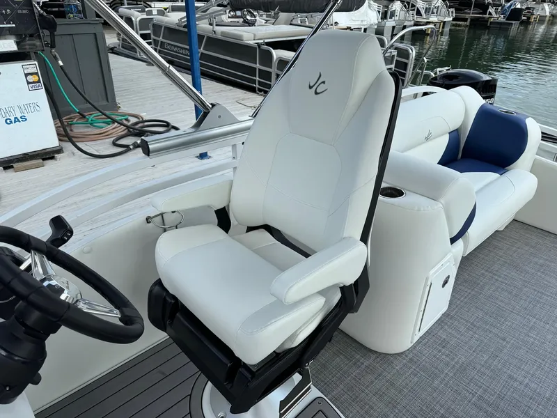 Slide: The Image of 2024 JC Spirit Super Sport 24TT DSL boat interior with white captain's chair and seating. - 15