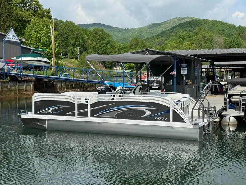 Slide: The Image of 2024 JC Spirit Super Sport 24TT DSL pontoon boat docked at a marina. - 3