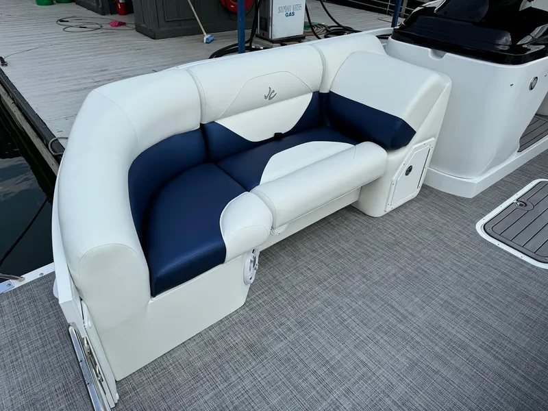 Slide: The Image of 2024 JC Spirit Super Sport 24TT DSL boat with white and navy blue seating. - 5