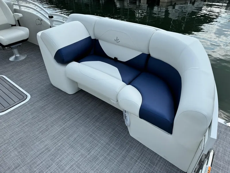 Slide: The Image of 2024 JC Spirit Super Sport 24TT DSL boat with luxurious white and blue seating. - 6