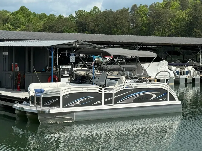 The Image of 2024 JC Spirit Super Sport 24TT DSL pontoon boat docked at a marina. - 1