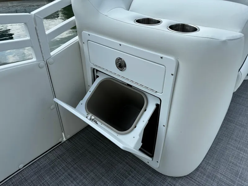 Slide: The Image of 2024 JC Spirit Super Sport 24TT DSL boat with built-in trash compartment and cup holders. - 10