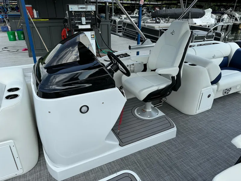 Slide: The Image of 2024 JC Spirit Super Sport 24TT DSL boat cockpit with white captain's chair and control console. - 13