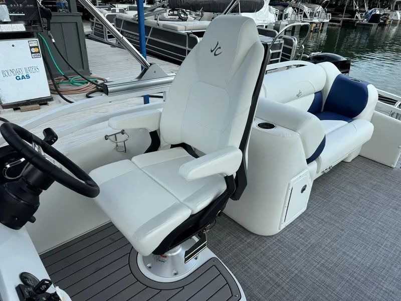 Slide: The Image of 2024 JC Spirit Super Sport 24TT DSL boat interior with captain's chair and seating. - 14