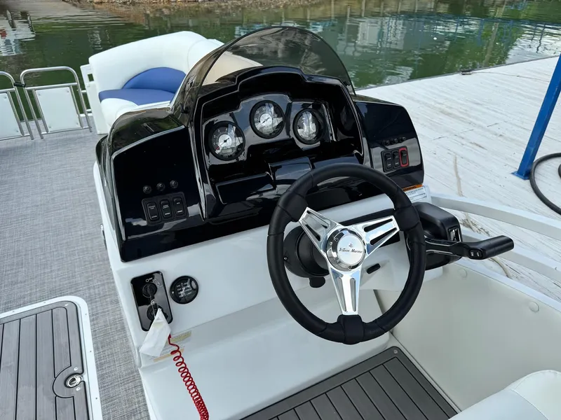 Slide: The Image of 2024 JC Spirit Super Sport 24TT DSL boat dashboard and steering wheel. - 16