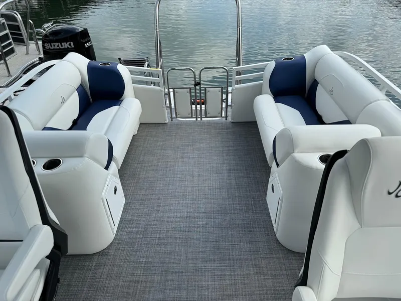 Slide: The Image of 2024 JC Spirit Super Sport 24TT DSL boat interior with white and blue seating. - 18