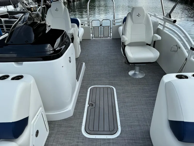 Slide: The Image of 2024 JC Spirit Super Sport 24TT DSL boat interior with seating and storage compartments. - 7
