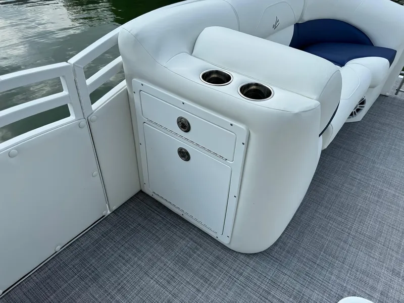 Slide: The Image of 2024 JC Spirit Super Sport 24TT DSL boat interior with cup holders and storage. - 9