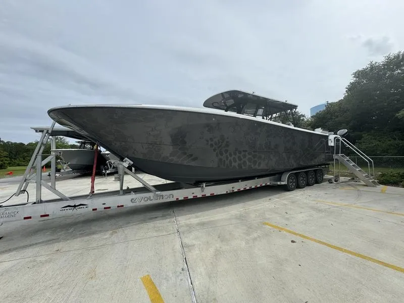 Slide: The Image of 2022 Invincible 46' Catamaran on a trailer in a parking lot. - 10