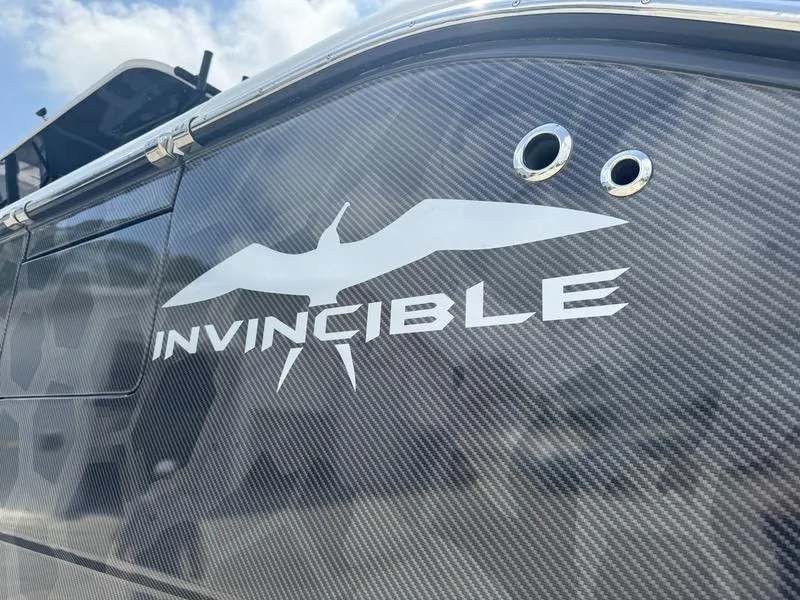 Slide: The Image of 2022 Invincible 46' Catamaran with logo and carbon fiber finish. - 12