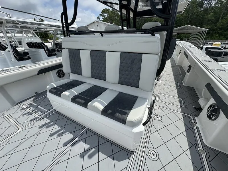 Slide: The Image of 2022 Invincible 46' Catamaran interior seating with gray and white upholstery. - 13