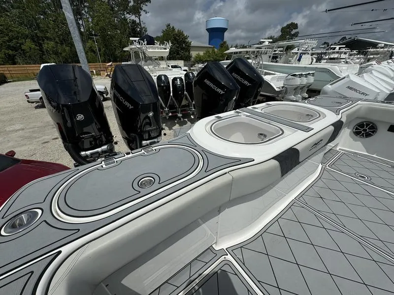 Slide: The Image of 2022 Invincible 46' Catamaran with multiple outboard engines docked at a marina. - 15