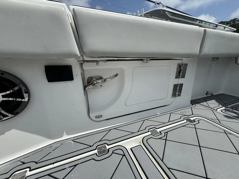 Slide: The Image of 2022 Invincible 46' Catamaran deck with storage compartment and cushioned seating. - 17