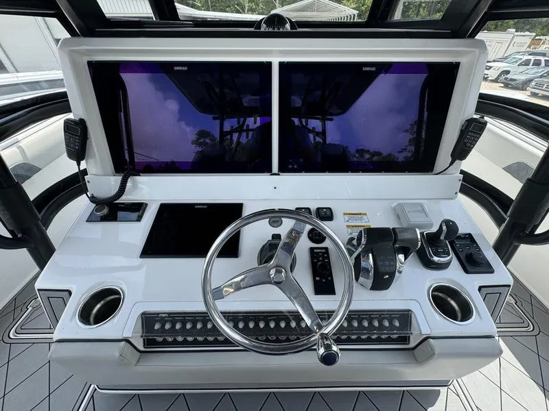 Slide: The Image of 2022 Invincible 46' Catamaran helm with dual screens and modern controls. - 23