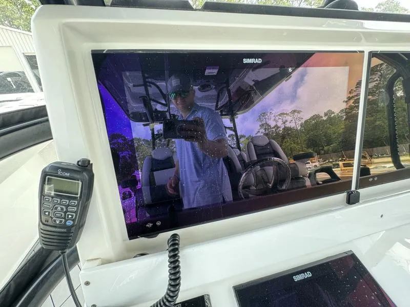 Slide: The Image of 2022 Invincible 46' Catamaran dashboard with Simrad display and radio. - 26