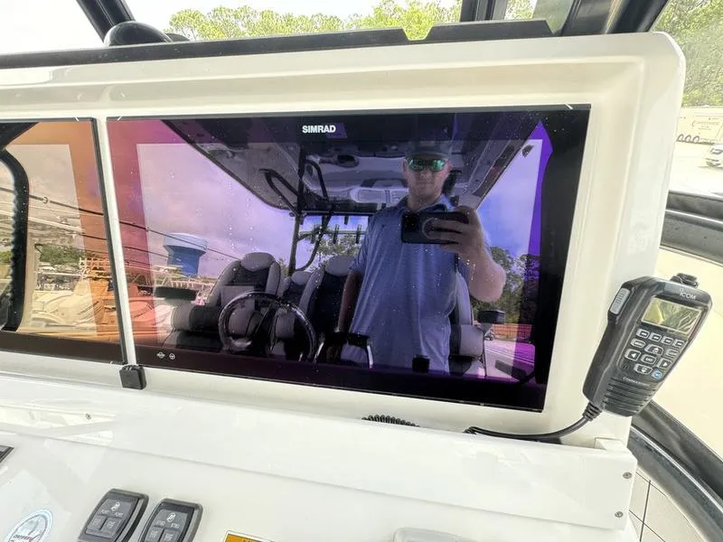 Slide: The Image of Control panel of 2022 Invincible 46' Catamaran with Simrad display and radio. - 27