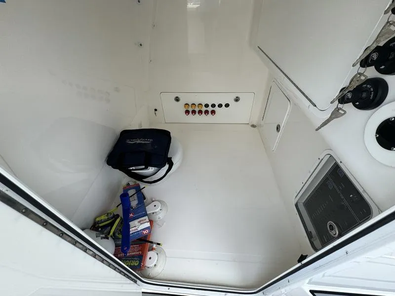 Slide: The Image of Interior storage compartment of 2022 Invincible 46' Catamaran with safety gear and control panel. - 28