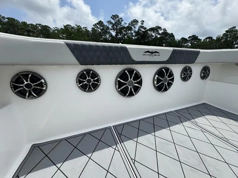 Slide: The Image of 2022 Invincible 46' Catamaran deck with multiple speakers and padded railing. - 32