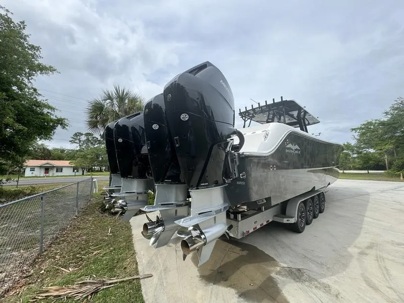 Slide: The Image of 2022 Invincible 46' Catamaran with triple outboard engines on a trailer. - 8
