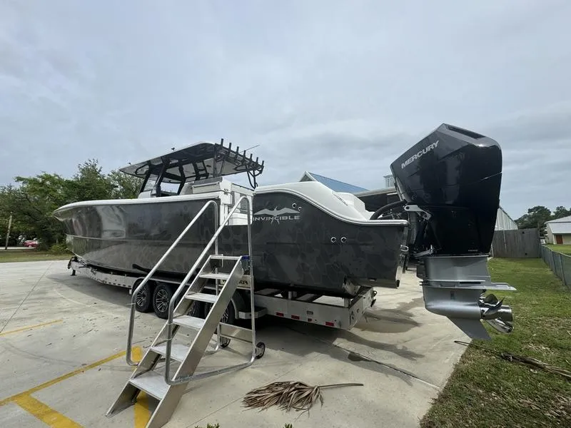 Slide: The Image of 2022 Invincible 46' Catamaran on trailer with Mercury outboard engines. - 9