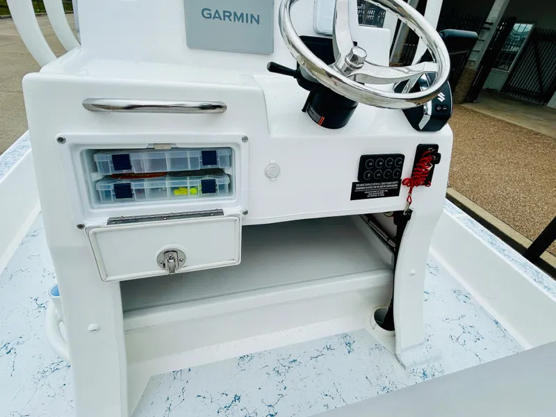 Slide: The Image of 2024 Shallow Sport 18 Sport boat console with Garmin navigation and storage compartments. - 11