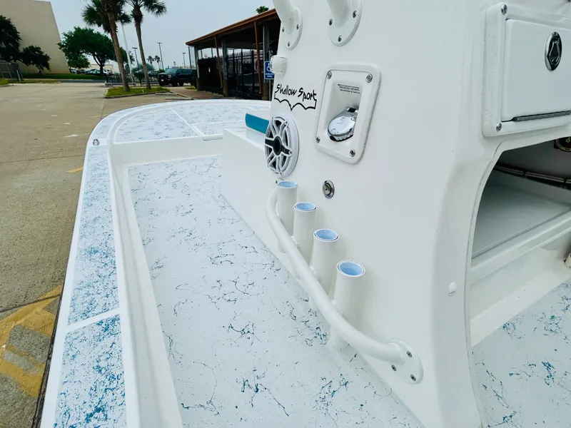 Slide: The Image of 2024 Shallow Sport 18 Sport boat interior with rod holders and speaker. - 12