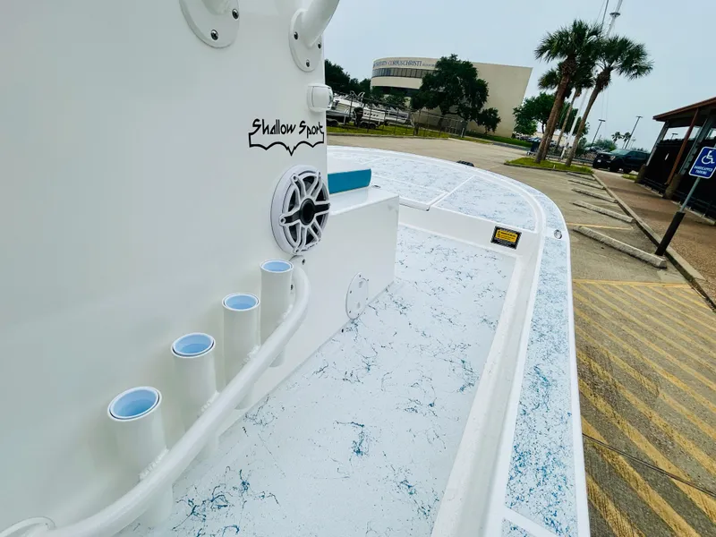 Slide: The Image of 2024 Shallow Sport 18 Sport boat deck with rod holders and speaker. - 14