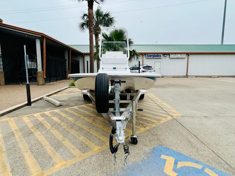 Slide: The Image of 2024 Shallow Sport 18 Sport boat on trailer in parking lot. - 2