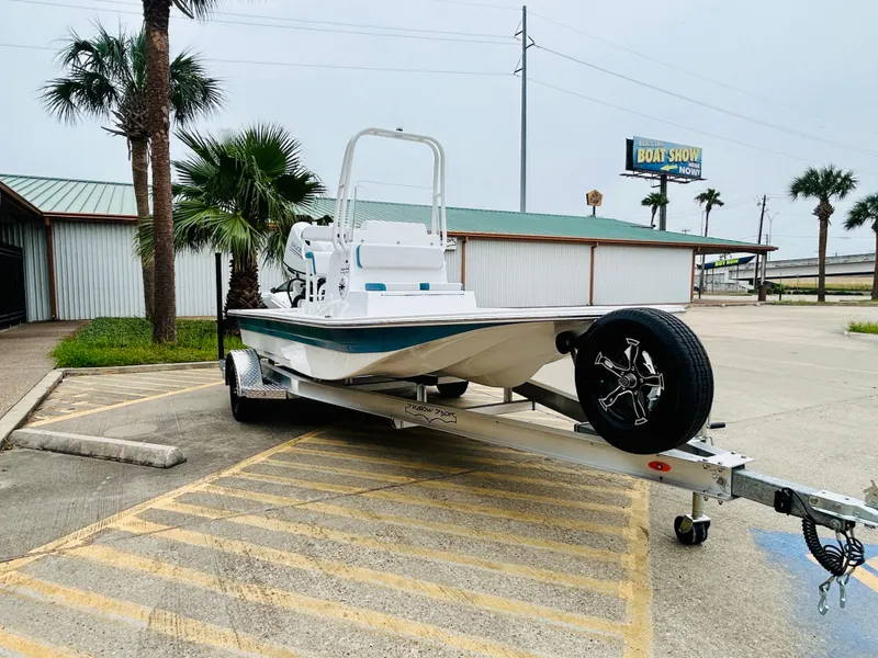 Slide: The Image of 2024 Shallow Sport 18 Sport boat on trailer in parking lot. - 3