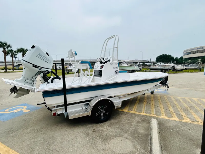 Slide: The Image of 2024 Shallow Sport 18 Sport boat on a trailer in a parking lot. - 4