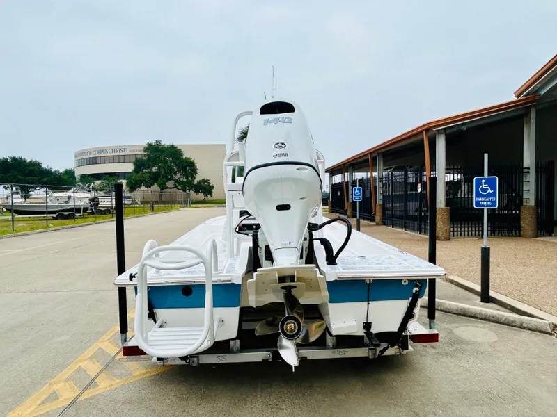 Slide: The Image of 2024 Shallow Sport 18 Sport boat with outboard motor in parking lot. - 5