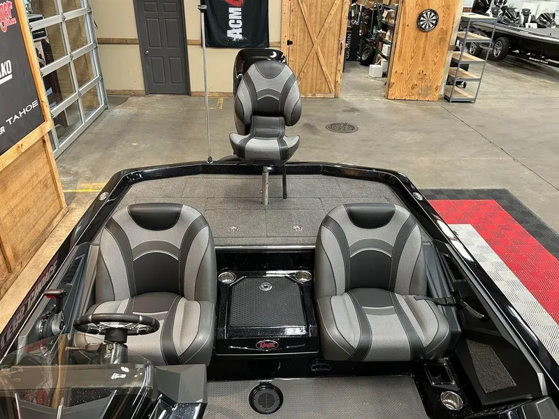 Slide: The Image of 2018 Ranger Z520L boat interior with three gray seats in a showroom. - 8