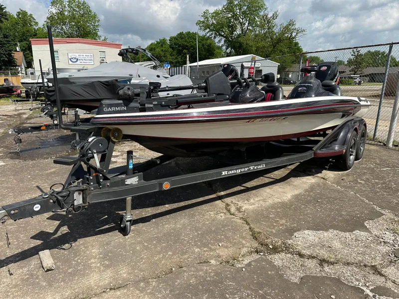 Slide: The Image of 2010 Ranger Z520 Comanche fishing boat on a trailer in a parking lot. - 13