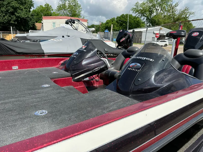 Slide: The Image of 2010 Ranger Z520 Comanche bass boat with dual consoles in a parking lot. - 14