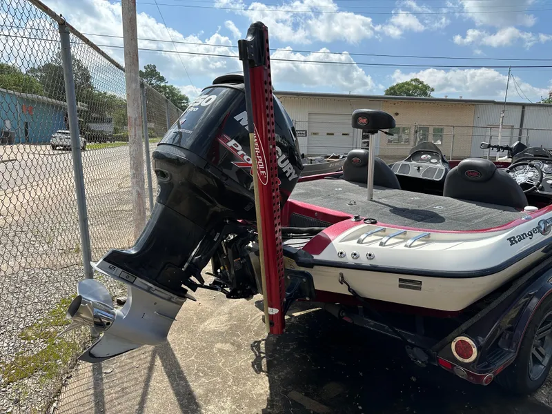Slide: The Image of 2010 Ranger Z520 Comanche boat with Mercury outboard motor in a parking lot. - 6