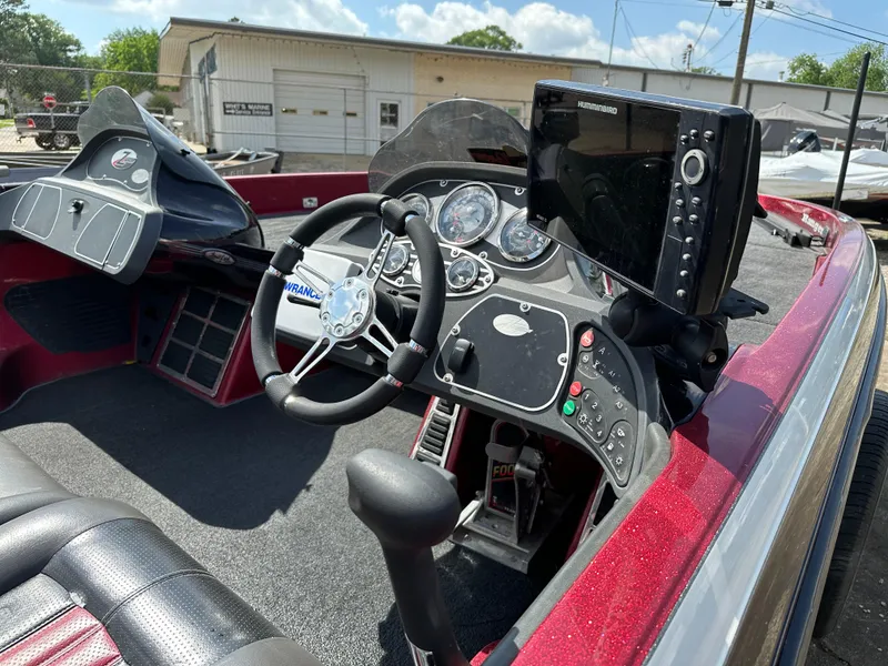 Slide: The Image of 2010 Ranger Z520 Comanche boat dashboard with steering wheel and electronic display. - 9